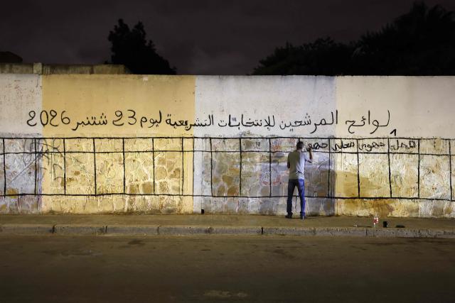 A worker marks a wall being designated as space for electoral posters to be displayed of various political parties ahead of the legislative election, along a street in Sale on September 9, 2026. Campaigning for Morocco's legislative election opened on September 10, with the governing coalition led by incumbent premier Aziz Akhannouch seeking to retain power amid persistent social and economic disparities. (Photo by Abdel Majid BZIOUAT / AFP)