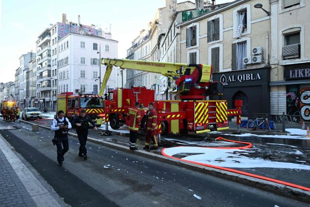 Firefighters and police gather at the site after a fire broke out overnight at Marché du Soleil in Marseille on September 10, 2026. (Photo by Miguel MEDINA / AFP)