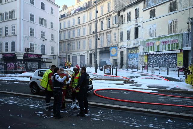 Firefighters and police gather at the site after a fire broke out overnight at Marché du Soleil in Marseille on September 10, 2026. (Photo by Miguel MEDINA / AFP)