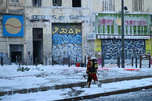 A firefimen walks amidst firefighting foam at the site after a fire broke out overnight at Marché du Soleil in Marseille on September 10, 2026. (Photo by Miguel MEDINA / AFP)