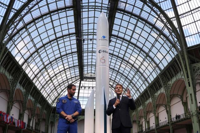 (FILES) France's President Emmanuel Macron (R) speaks flanked by French European Space Agency (ESA) astronaut Thomas Pesquet during the International Space Summit at the Grand Palais in Paris on September 9, 2026. Macron called for “shared governance” of space, with regulation that is “commensurate with the challenges”, and for Europe to become one of the “leading global players in this sector”. (Photo by Ludovic MARIN / POOL / AFP)