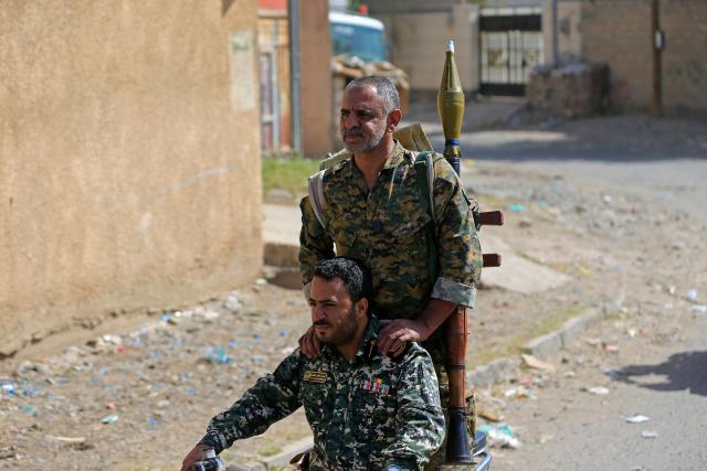 Yemeni gunmen ride a motorbike during a rally to recruit more fighters in Sanaa on September 10, 2026. The country relapsed into war in July after years of calm, drawn into the regional conflict triggered by the US-Israeli offensive against Iran that began at the end of February. (Photo by Mohammed HUWAIS / AFP)