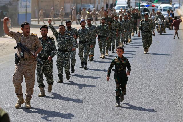 Yemeni gunmen march during a rally to recruit more fighters in Sanaa on September 10, 2026. The country relapsed into war in July after years of calm, drawn into the regional conflict triggered by the US-Israeli offensive against Iran that began at the end of February. (Photo by Mohammed HUWAIS / AFP)
