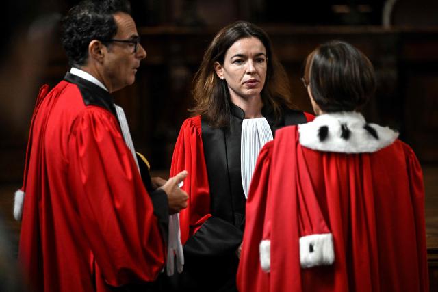 Newly-appointed magistrate at the Office of the Attorney General of the Court of Appeal of Bordeaux Clemence Meyer (C)  speaks with colleagues ahead  of the installation ceremony, in Bordeaux, in southwestern France, on September 10, 2026. (Photo by Christophe ARCHAMBAULT / AFP)