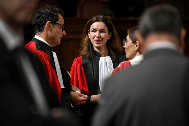 Newly-appointed magistrate at the Office of the Attorney General of the Court of Appeal of Bordeaux Clemence Meyer (C)  speaks with colleagues ahead  of the installation ceremony, in Bordeaux, in southwestern France, on September 10, 2026. (Photo by Christophe ARCHAMBAULT / AFP)