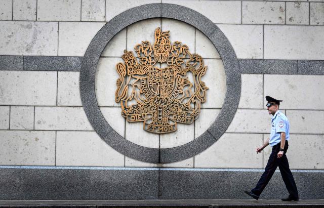 A Russian police officer walks by the United Kingdom's Coat of Arms on a wall of the British Embassy in Moscow on September 10, 2026. Russia's FSB security service said on September 10, 2026 it had detained a Russian security guard working at the British embassy in Moscow, alleging he had been hired by Ukraine to carry out a false flag attack on the UK ambassador. (Photo by Alexander NEMENOV / AFP)