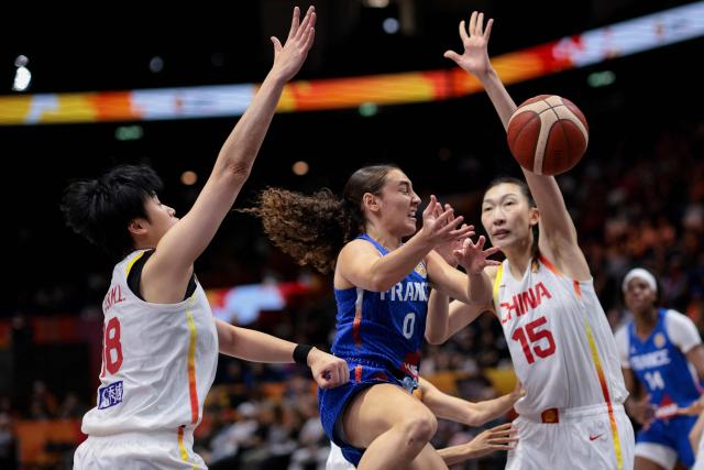 (L-R) China's center #18 Chen Mingling, France's point guard #0 Carla Leite and China's center #15 Han Xu vie for the ball during the 2026 FIBA Women's Basketball World Cup quarter-final match between China and France at the Berlin Arena in Berlin on September 10, 2026. (Photo by Ronny HARTMANN / AFP)