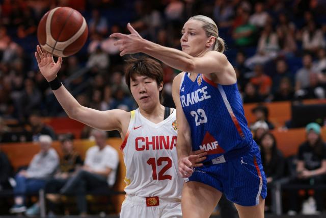 France's shooting guard #23 Marine Johannes (R) and China's shooting guard #12 Chen Yujie vie for the ball during the 2026 FIBA Women's Basketball World Cup quarter-final match between China and France at the Berlin Arena in Berlin on September 10, 2026. (Photo by Ronny HARTMANN / AFP)