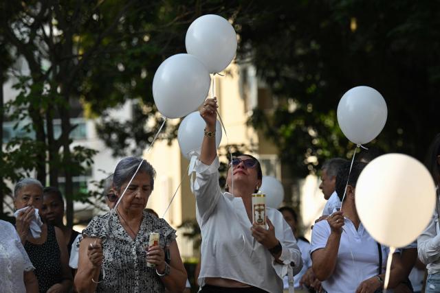 Relatives of the victims of the 7.4- magnitude earthquake take part in a ceremony in honor of the victims one month after the tragedy at Parroquia Maria Inmaculada, near Torres del Limonar, in Cali, Colombia on September 10, 2026. (Photo by JOAQUIN SARMIENTO / AFP)