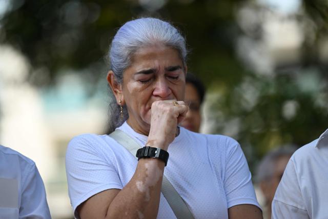 A relative of the victims of the 7.4- magnitude earthquake takes part in a ceremony in honor of the victims one month after the tragedy at Maria Inmaculada Church, near Torres del Limonar, in Cali, Colombia on September 10, 2026. (Photo by JOAQUIN SARMIENTO / AFP)