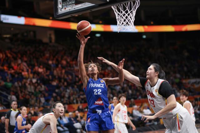 France's center #22 Marieme Badiane (C) attempts to score past China's center #19 Zhang Ziyu (R) during the 2026 FIBA Women's Basketball World Cup quarter-final match between China and France at the Berlin Arena in Berlin on September 10, 2026. (Photo by Ronny HARTMANN / AFP)