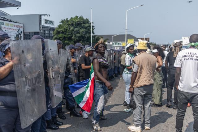 Protestors from the anti-illegal immigration group, March and March Movement demonstrate during a protest in Durban, on September 10, 2026. The group is calling for tougher action against illegal immigration and the deportation of undocumented foreign nationals. Documented refugees from the Democratic Republic of Congo, Burundi and Rwanda have been living on the streets for about four months after fleeing communities where they say they faced hostility, threats and intimidation. The protest in Durban comes amid weeks of demonstrations against irregular migration where tens of thousands have fled the country. (Photo by RAJESH JANTILAL / AFP)