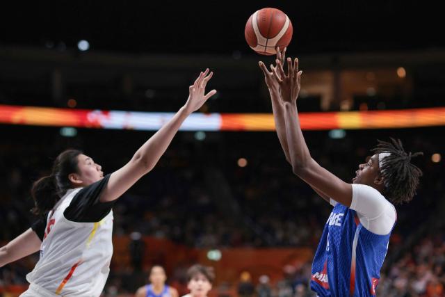 France's center #14 Dominique Malonga (R) shoots past China's center #19 Zhang Ziyu during the 2026 FIBA Women's Basketball World Cup quarter-final match between China and France at the Berlin Arena in Berlin on September 10, 2026. (Photo by Ronny HARTMANN / AFP)