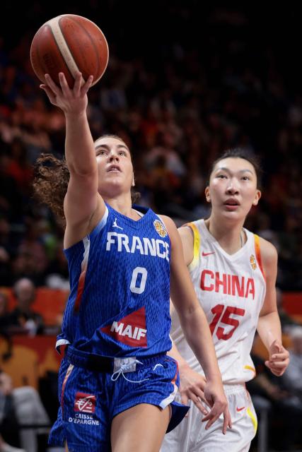 France's point guard #0 Carla Leite (L) gets past China's center #15 Han Xu with the ball during the 2026 FIBA Women's Basketball World Cup quarter-final match between China and France at the Berlin Arena in Berlin on September 10, 2026. (Photo by Ronny HARTMANN / AFP)