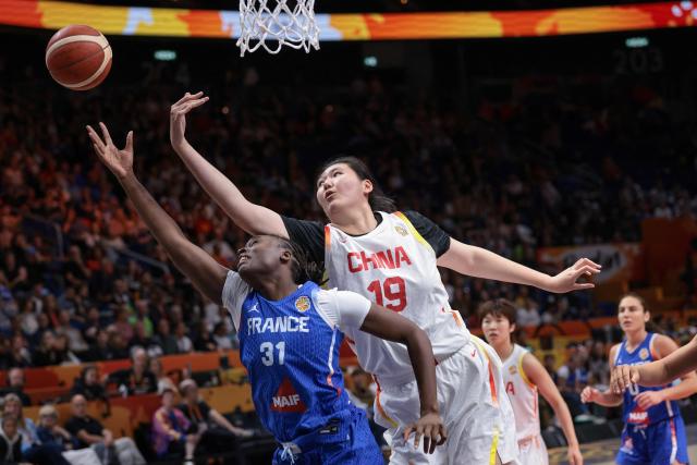 France's center #31 Aminata Gueye (L) and China's center #19 Zhang Ziyu vie for the ball during the 2026 FIBA Women's Basketball World Cup quarter-final match between China and France at the Berlin Arena in Berlin on September 10, 2026. (Photo by Ronny HARTMANN / AFP)