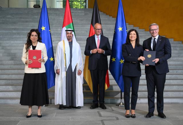 German Chancellor Friedrich Merz (C) poses next to UAE President Sheikh Mohamed bin Zayed Al-Nahyan (2L) and German Economy and Energy Minister Katherina Reiche (2R) and German Minister for Digitalization and State Modernization Karsten Wildberger (R) at the Chancellery in Berlin on September 10, 2026. The leader of the United Arab Emirates is on a two-day-visit to Germany during which, Emirati diplomats said, AI and energy deals worth several billion euros will be signed. (Photo by RALF HIRSCHBERGER / AFP)