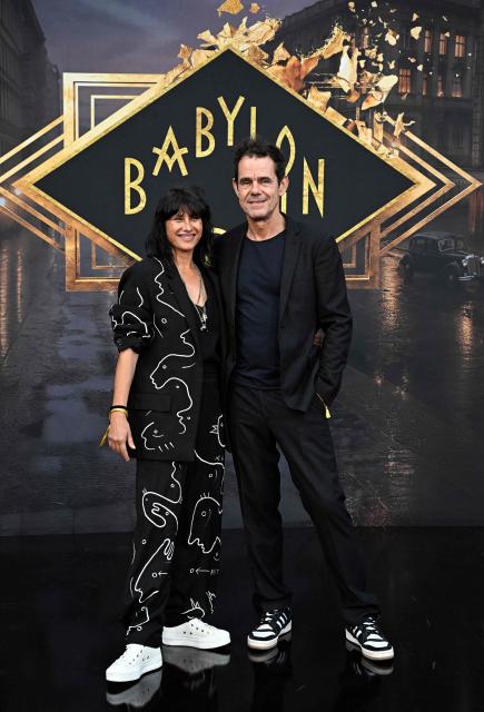 German film director and screenwriter Tom Tykwer (R) and his partner Marie Steinmann pose on the red carpet for the TV Hit Babylon Berlin last season at the Zoopalast cinema in Berlin, on September 10, 2026. The lavishly produced, big-budget ARD series is set against the backdrop of Hitler’s rise to power. (Photo by Tobias SCHWARZ / AFP)