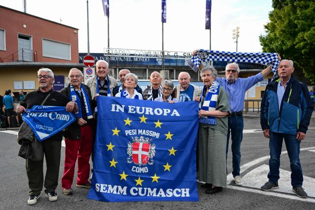 Supporters of the football club of Como 1907, who were born in 1950 or earlier and who were offered seats by the Como 1907 football club president for them to watch in person the club's first-ever Champions League match, pose ahead of the start ofthe UEFA Champions League, league phase, matchday 1, football match between Como 1907 and RB Leipzig at the Giuseppe Sinigaglia stadium in Como, on September 10, 2026. (Photo by PIERO CRUCIATTI / AFP)