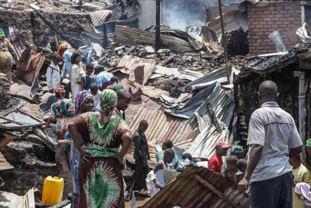 TOPSHOT - Residents stand at the debris of a fire who ravaged a school in Bukavu, on September 10, 2026. A fire broke out Thursday in a school in the eastern DR Congo city of Bukavu, causing a stampede that killed at least 14 children, local and health sources said.
The blaze began while the children were in lessons, forcing some to try to escape by jumping from higher floors, a teacher told AFP.
Large columns of smoke were still visible around the site of the fire at midday on Thursday, an AFP correspondent saw. (Photo by Joseph Amani Alimasi / AFP)