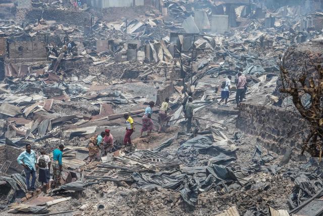 TOPSHOT - Residents walk among the debris of a fire who ravaged a school in Bukavu, on September 10, 2026. A fire broke out Thursday in a school in the eastern DR Congo city of Bukavu, causing a stampede that killed at least 14 children, local and health sources said.
The blaze began while the children were in lessons, forcing some to try to escape by jumping from higher floors, a teacher told AFP.
Large columns of smoke were still visible around the site of the fire at midday on Thursday, an AFP correspondent saw. (Photo by Joseph Amani Alimasi / AFP)