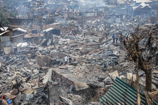 Residents walk among the debris of a fire who ravaged a school in Bukavu, on September 10, 2026. A fire broke out Thursday in a school in the eastern DR Congo city of Bukavu, causing a stampede that killed at least 14 children, local and health sources said.
The blaze began while the children were in lessons, forcing some to try to escape by jumping from higher floors, a teacher told AFP.
Large columns of smoke were still visible around the site of the fire at midday on Thursday, an AFP correspondent saw. (Photo by Joseph Amani Alimasi / AFP)