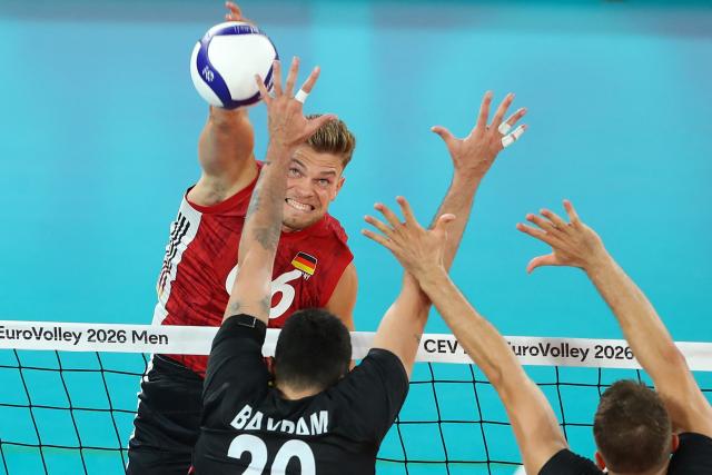 Germany's outside spiker Erik Rohrs (L) vies Turkey's outside spiker Efe Bayram (C) during the EuroVolley 2026 volleyball Pool D match Turkey vs Germany in Cluj Napoca, Romania, September 10, 2026. (Photo by Simion Sebastian Tataru / AFP)