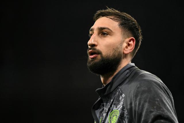 (FILES) Manchester City's Italian goalkeeper #25 Gianluigi Donnarumma warms up ahead of the UEFA Champions League, round of 16 second leg football match between Manchester City and Real Madrid at the Etihad Stadium in Manchester, north west England, on March 17, 2026. With insults flying from the dock and relatives being ejected from the courtroom, the trial of three men accused of the traumatic burglary in July 2023 at the home of Italian goalkeeper Gianluigi Donnarumma took place in a chaotic atmosphere on September 10, 2026 at the Paris court. (Photo by Oli SCARFF / AFP)