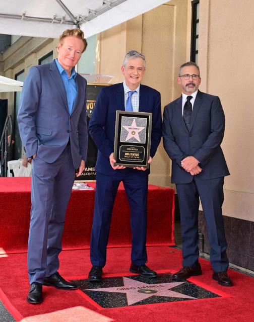 Screenwriter and television producer Greg Daniels stands on his newly unveiled Hollywood Walk of Fame star with TV host Conan O'Brien (L) and actor Steve Carell (R) during a ceremony in Hollywood, California, on September 10, 2026. (Photo by Frederic J. BROWN / AFP)