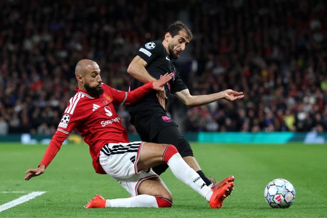 Manchester United's Moroccan defender #03 Noussair Mazraoui tackles Sabah FK's Azerbaijani midfielder #06 Abdulakh Khaybulayev during the UEFA Champions League football match between Manchester United and Sabah FK at Old Trafford in Manchester, north west England, on September 10, 2026. (Photo by Darren Staples / AFP)