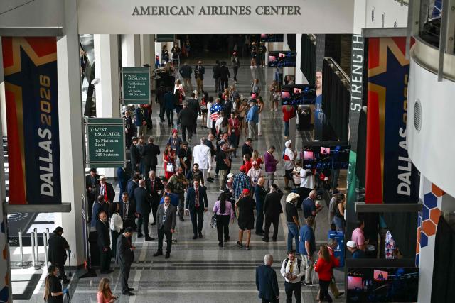 Attendees walk through the concourse at the American Airlines Center during the second day of the Republican National Committee midterm convention in Dallas, Texas on September 10, 2026. US Republicans are betting that putting President Donald Trump at the center of their campaign can rescue a party facing grim election forecasts, despite the president's negative approval ratings. A day earlier, on the first day of the midterm convention, he promised $5,000 to every American adult if Republicans retain control of Congress in November. (Photo by Kent NISHIMURA / AFP)