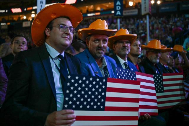 Attendees from Wisconsin hold American flag placards during the second day of the Republican National Committee midterm convention at the American Airlines Center in Dallas, Texas on September 10, 2026. US Republicans are betting that putting President Donald Trump at the center of their campaign can rescue a party facing grim election forecasts, despite the president's negative approval ratings. A day earlier, on the first day of the midterm convention, he promised $5,000 to every American adult if Republicans retain control of Congress in November. (Photo by Kent NISHIMURA / AFP)