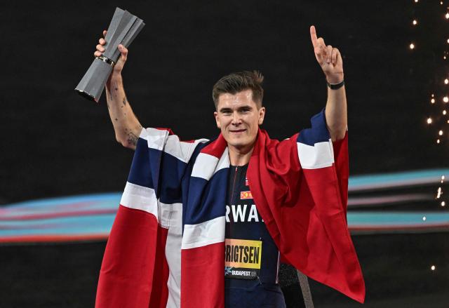 Norway's Jakob Ingebrigtsen celebrates with the trophy after winning the men's 5000m final during the World Athletics Ultimate Championship at the Gyula Zsivotzky National Athletics Centre, in Budapest on September 11, 2026. (Photo by Attila KISBENEDEK / AFP)