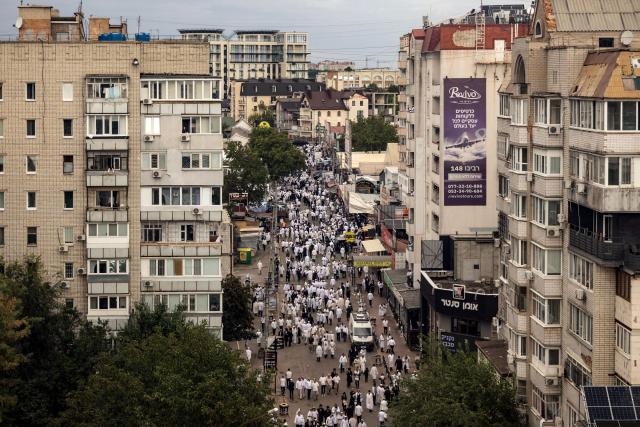 Hasidic Jewish pilgrims gather along a street near the tomb of Rabbi Nachman ahead of the Jewish New Year, Rosh Hashanah, in Uman, central Ukraine, on September 12, 2026, amid the Russian invasion of Ukraine. Tens of thousands of Jewish pilgrims flock to the Ukrainian city of Uman despite the war for their annual pilgrimage to the tomb of Rabbi Nachman of Breslov (1772–1810), founder of the Breslov Hasidic movement, which established a community in Uman in the early 19th century. (Photo by Serhii Okunev / AFP)