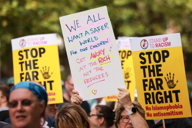 People take part in an anti-far right demonstration in the city of Portsmouth, southern England on September 12, 2026. Protesters at planned anti-immigration and counter-demonstration rallies in southern England were expected to be banned from wearing face masks, police said on September 11, amid fears of unrest. (Photo by Brook Mitchell / AFP)