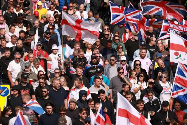 People take part in an anti-immigration demonstration and march in the streets in the city of Portsmouth, southern England on September 12, 2026. Protesters at planned anti-immigration and counter-demonstration rallies in southern England were expected to be banned from wearing face masks, police said on September 11, amid fears of unrest. (Photo by Brook Mitchell / AFP)