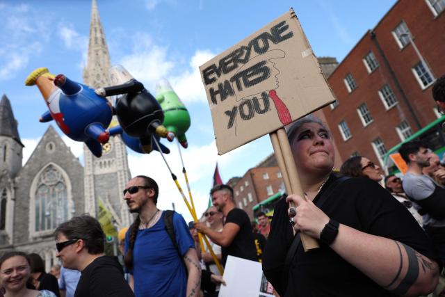People take part in a protest against the visit of US President Donald Trump in the Irish capital Dublin on September 12, 2026. Trump arrived in Ireland on September 12 for a two-day visit, stopping for a few hours in Dublin before heading west to his Trump International Golf Links to attend the Irish Open. (Photo by Adrian Dennis / AFP)