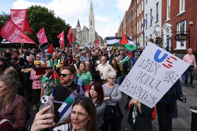 People take part in a protest against the visit of US President Donald Trump in the Irish capital Dublin on September 12, 2026. Trump arrived in Ireland on September 12 for a two-day visit, stopping for a few hours in Dublin before heading west to his Trump International Golf Links to attend the Irish Open. (Photo by Adrian Dennis / AFP)