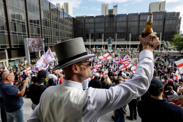 People take part in an anti-immigration demonstration and march gather in the city of Portsmouth, southern England on September 12, 2026. Protesters at planned anti-immigration and counter-demonstration rallies in southern England were expected to be banned from wearing face masks, police said on September 11, amid fears of unrest. (Photo by Brook Mitchell / AFP)