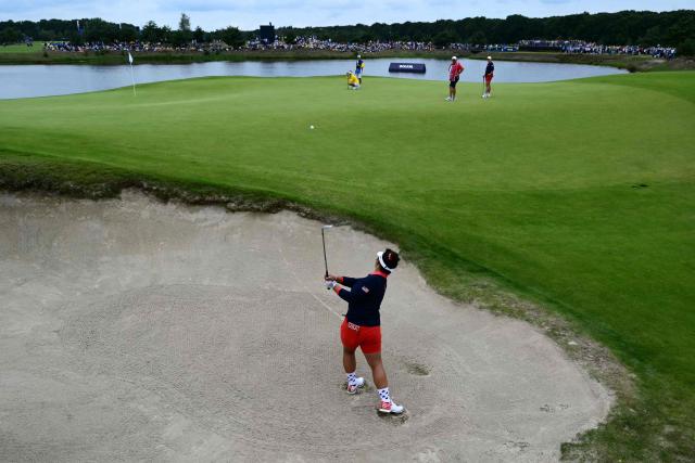 TOPSHOT - US teams golfer Megan Khang hits out of a bunker during play in her fourball match against Team Europe players on the second day of the 2026 Solheim Cup biennial team golf competition on The Bernardus Golf Course at Cromvoirt, some 80kms south-east of Rotterdam on September 12, 2026. (Photo by NICOLAS TUCAT / AFP)