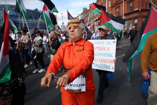 People take part in a protest against the visit of US President Donald Trump in the Irish capital Dublin on September 12, 2026. Trump arrived in Ireland on September 12 for a two-day visit, stopping for a few hours in Dublin before heading west to his Trump International Golf Links to attend the Irish Open. (Photo by Adrian Dennis / AFP)
