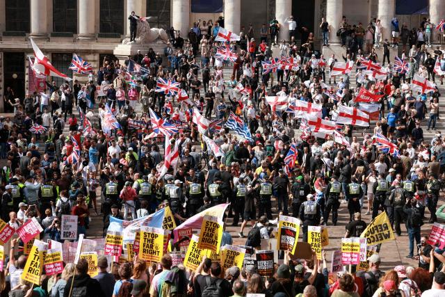 People taking part in an anti-immigration demonstration and march (top) square off with anti-far right demonstrators (bottom) in the city of Portsmouth, southern England on September 12, 2026. Protesters at planned anti-immigration and counter-demonstration rallies in southern England were expected to be banned from wearing face masks, police said on September 11, amid fears of unrest. (Photo by Brook Mitchell / AFP)