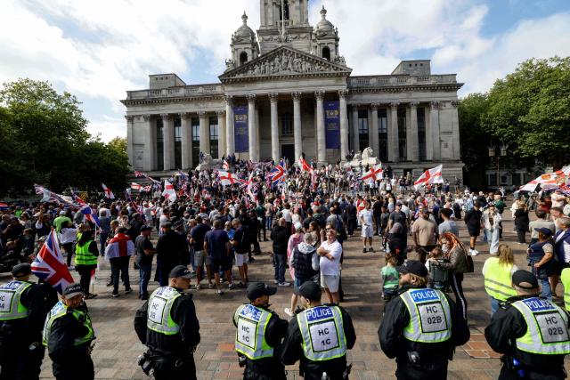 People take part in an anti-immigration demonstration and march in the city of Portsmouth, southern England on September 12, 2026. Protesters at planned anti-immigration and counter-demonstration rallies in southern England were expected to be banned from wearing face masks, police said on September 11, amid fears of unrest. (Photo by Brook Mitchell / AFP)