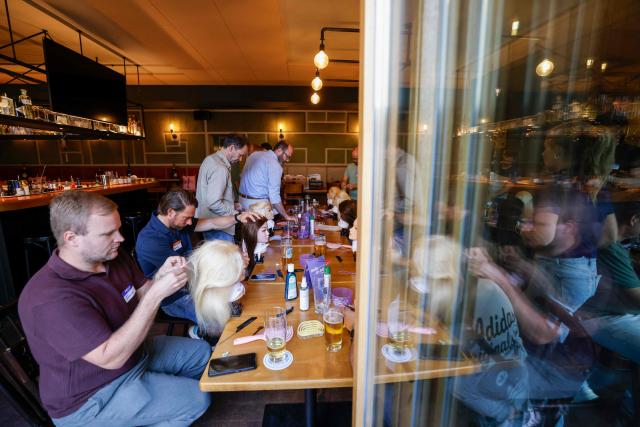 Men train to do pigtails at a doll during hair braiding course ‚dads do hair‘ in a restaurant in Munich, Bavaria, southern Germany, on September 12, 2026. (Photo by Michaela STACHE / AFP)