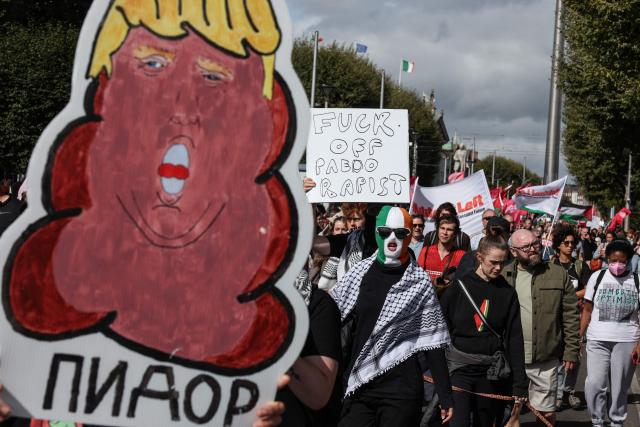 People take part in a protest against the visit of US President Donald Trump in the Irish capital Dublin on September 12, 2026. Trump arrived in Ireland on September 12 for a two-day visit, stopping for a few hours in Dublin before heading west to his Trump International Golf Links to attend the Irish Open. (Photo by Adrian Dennis / AFP)