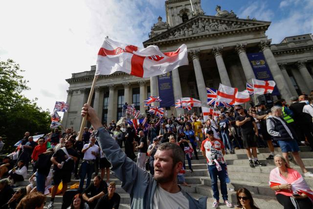 People take part in an anti-immigration demonstration and march in the city of Portsmouth, southern England on September 12, 2026. Protesters at planned anti-immigration and counter-demonstration rallies in southern England were expected to be banned from wearing face masks, police said on September 11, amid fears of unrest. (Photo by Brook Mitchell / AFP)