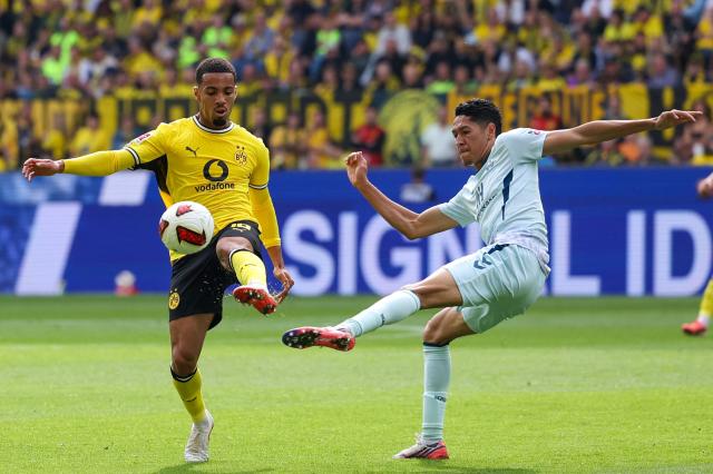 Dortmund's English forward #18 Ethan Nwaneri and Paderborn's US midfielder #05 Santiago Castaneda vie for the ball during the German first division Bundesliga football match between Borussia Dortmund and SC Paderborn in Dortmund on September 12, 2026. (Photo by Leon Kuegeler / AFP) / DFL REGULATIONS PROHIBIT ANY USE OF PHOTOGRAPHS AS IMAGE SEQUENCES AND/OR QUASI-VIDEO