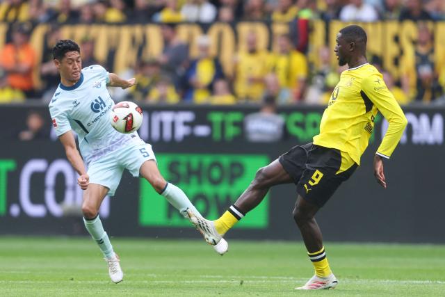 Paderborn's US midfielder #05 Santiago Castaneda and Dortmund's Guinean forward #09 Serhou Guirassy vie for the ball during the German first division Bundesliga football match between Borussia Dortmund and SC Paderborn in Dortmund on September 12, 2026. (Photo by Leon Kuegeler / AFP) / DFL REGULATIONS PROHIBIT ANY USE OF PHOTOGRAPHS AS IMAGE SEQUENCES AND/OR QUASI-VIDEO