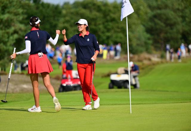 US teams golfer Yealimi Noh (L) celebrates with partner US teams golfer Andrea Lee on a green after making a putt during play in her fourball match against Team Europe players on the second day of the 2026 Solheim Cup biennial team golf competition on The Bernardus Golf Course at Cromvoirt, some 80kms south-east of Rotterdam on September 12, 2026. (Photo by NICOLAS TUCAT / AFP)