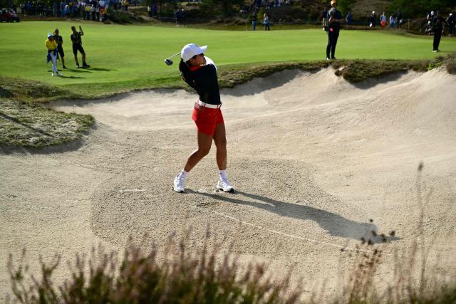 US teams golfer Auston Kim hits out of a bunker during play in her fourball match against Team Europe players on the second day of the 2026 Solheim Cup biennial team golf competition on The Bernardus Golf Course at Cromvoirt, some 80kms south-east of Rotterdam on September 12, 2026. (Photo by NICOLAS TUCAT / AFP)