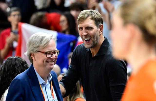 German former NBA basketball player Dirk Nowitzki (R) reacts prior to the start of the 2026 FIBA Women's Basketball World Cup semi-final match between France and Germany in Berlin on September 12, 2026. (Photo by Tobias SCHWARZ / AFP)